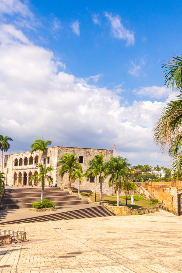 Historic stone building with palm trees in the Zona Colonial of Santo Domingo